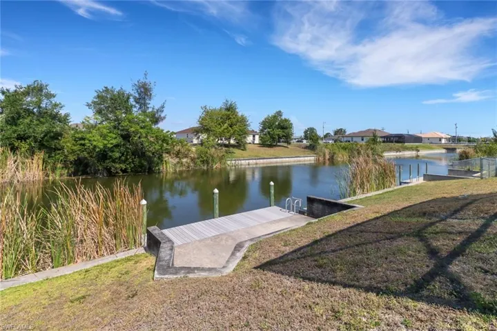 Dock featuring a water view and a residential view