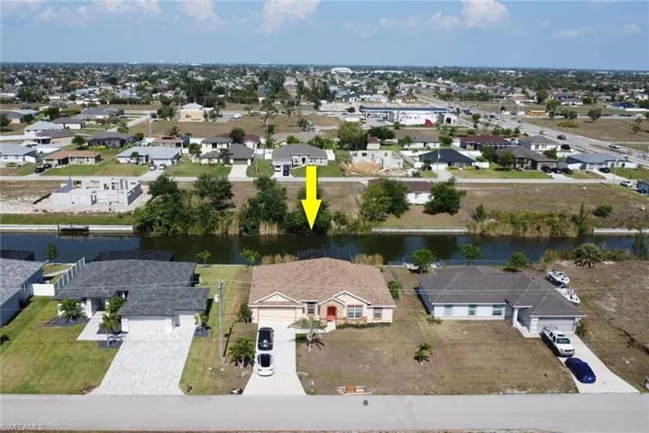 Aerial perspective of suburban area with a large body of water