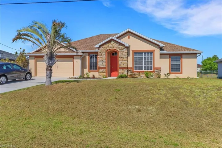 Single story home featuring stucco siding, stone siding, an attached garage, driveway, and a front lawn