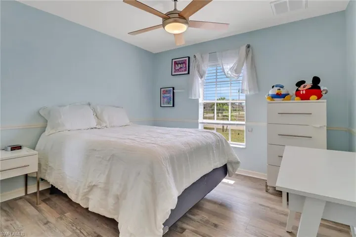 Bedroom with wood finished floors and ceiling fan