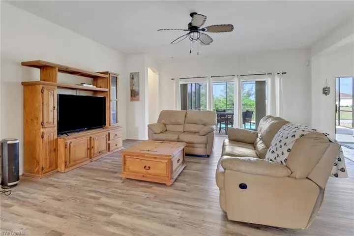 Living area featuring light wood-type flooring and a ceiling fan
