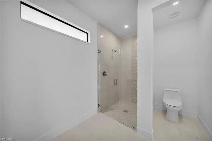 Full bathroom with a stall shower and recessed lighting