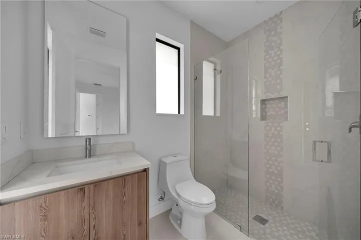 Full bathroom featuring a stall shower and vanity