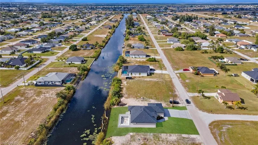 View of property location with a large body of water and nearby suburban area
