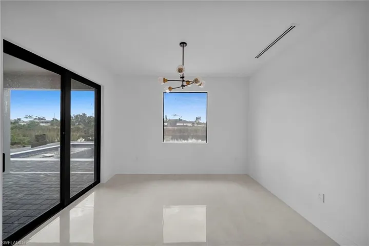 Spare room with hanging lights and baseboards