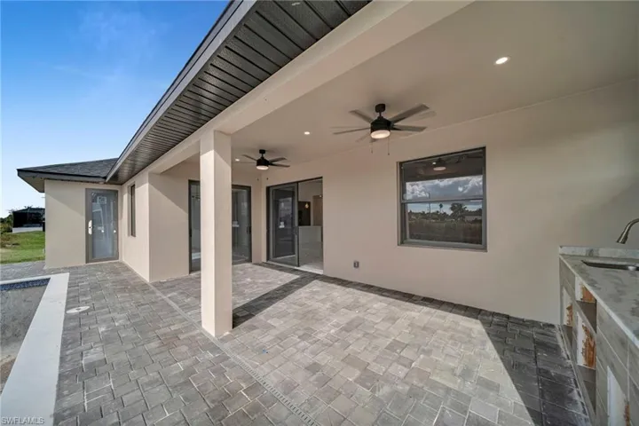 View of patio / terrace with a ceiling fan and a sink
