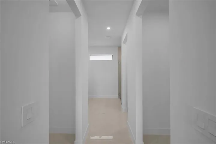 Hallway featuring baseboards and recessed lighting