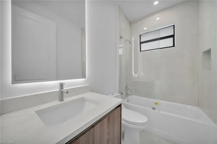 Bathroom featuring vanity and bathing tub / shower combination