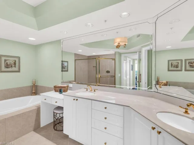 Bathroom featuring plus walk in shower, tile patterned floors, and vanity