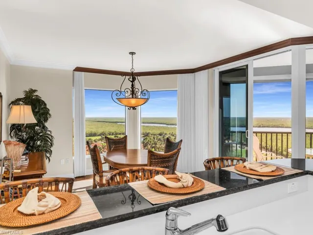 Dining area with hardwood / wood-style flooring and ornamental molding