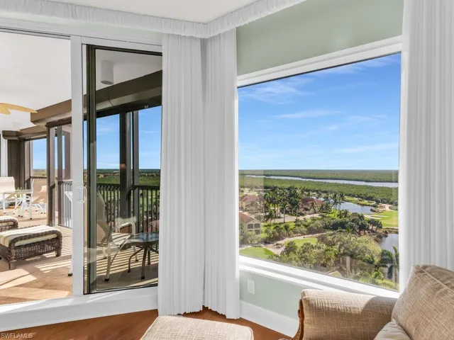Doorway to outside with hardwood / wood-style floors and a water view