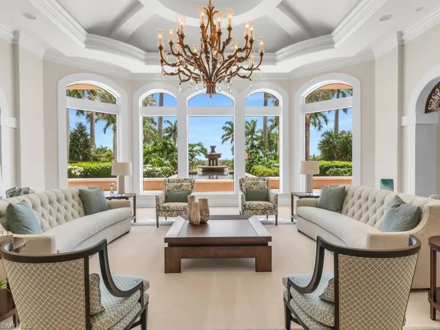 Sunroom / solarium with coffered ceiling and an inviting chandelier