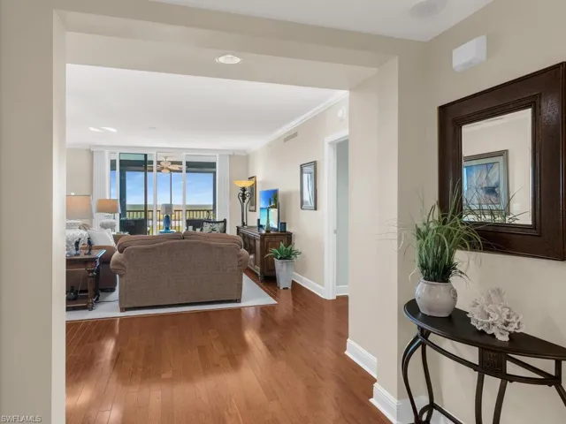 Living room featuring crown molding and hardwood / wood-style flooring
