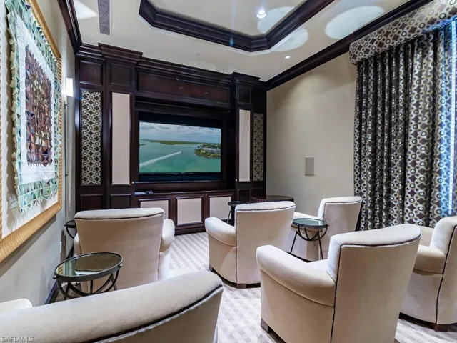 Home theater room with crown molding and a tray ceiling