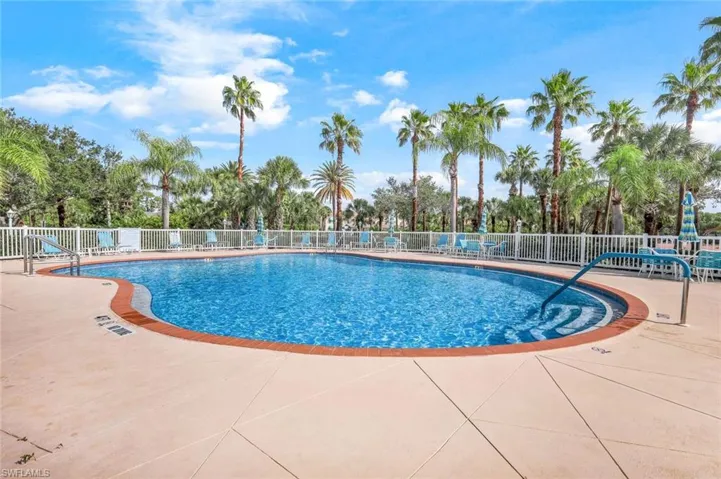 Community pool with a patio