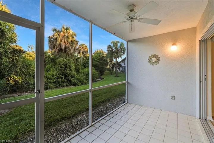 Unfurnished sunroom with ceiling fan