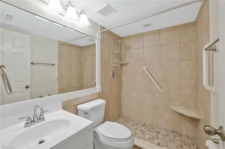 Bathroom featuring vanity and a tile shower