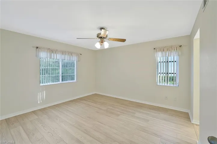 Unfurnished room with light wood-type flooring and ceiling fan