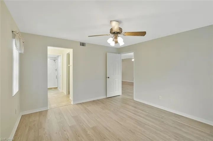 Unfurnished room with light wood finished floors and ceiling fan