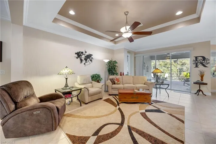 Tiled living room with a tray ceiling and crown molding