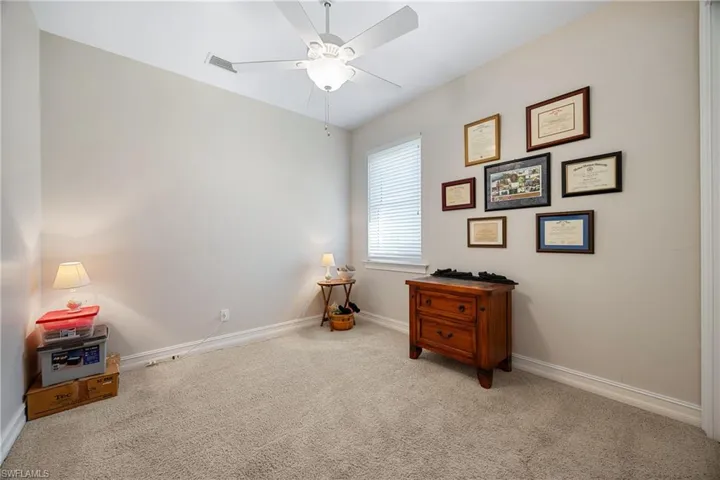 Misc room featuring light carpet and ceiling fan