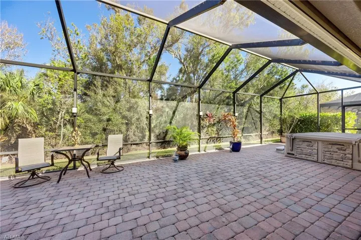 View of patio featuring glass enclosure