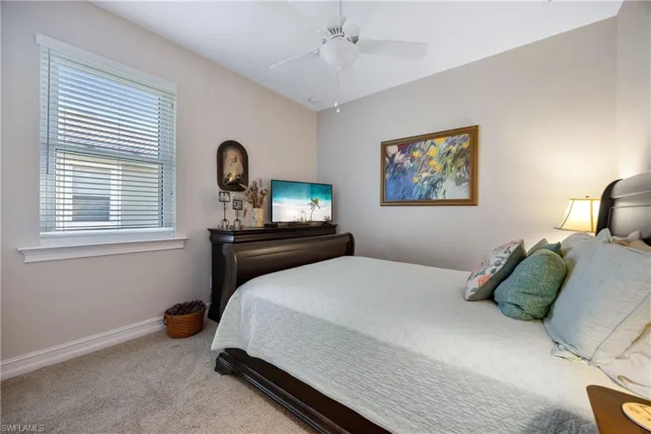Carpeted bedroom with ceiling fan
