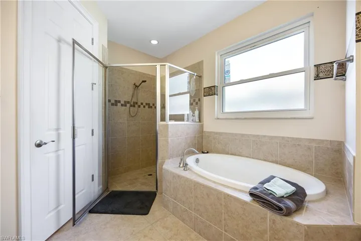 Bathroom with tile patterned floors and independent shower and bath
