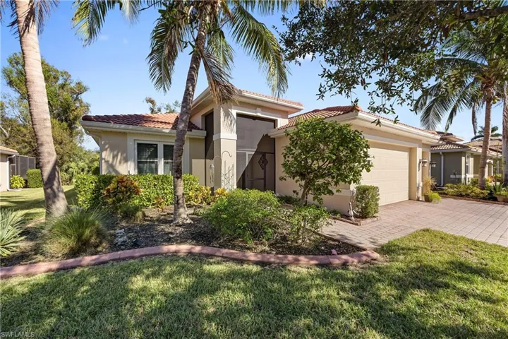 Mediterranean / spanish house featuring a front yard and a garage