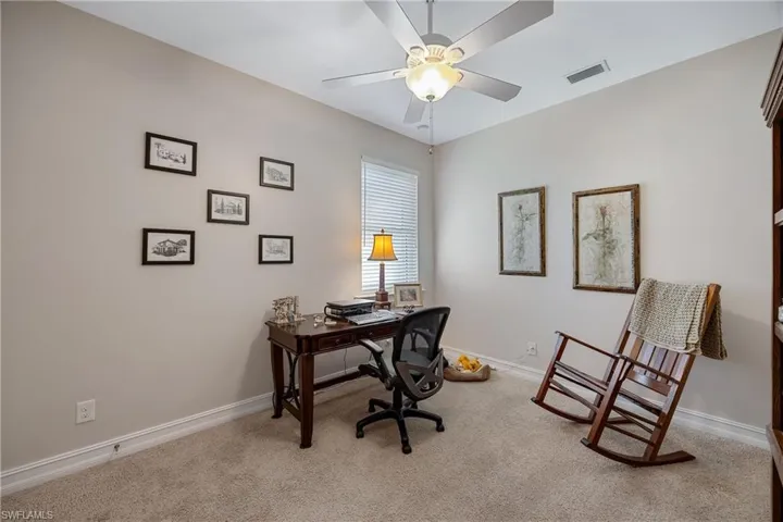 Office space featuring ceiling fan and light colored carpet