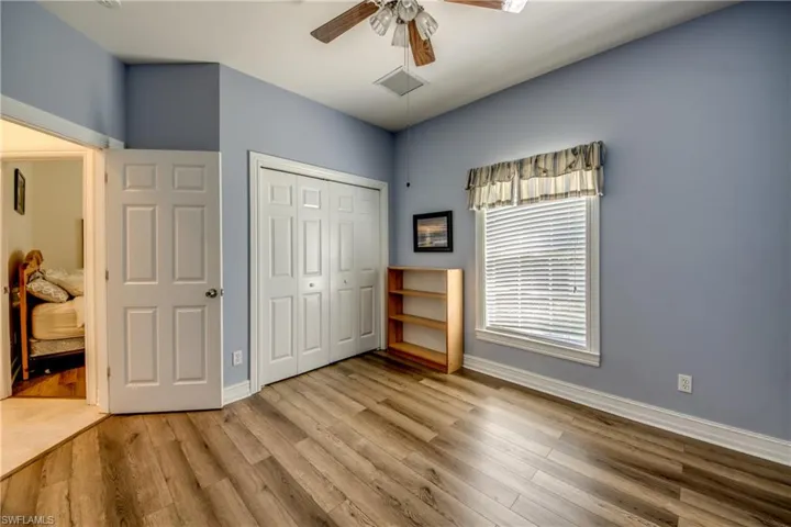 Unfurnished bedroom featuring wood finished floors, a closet, and a ceiling fan