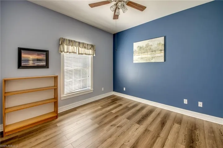 Unfurnished room with ceiling fan and wood finished floors