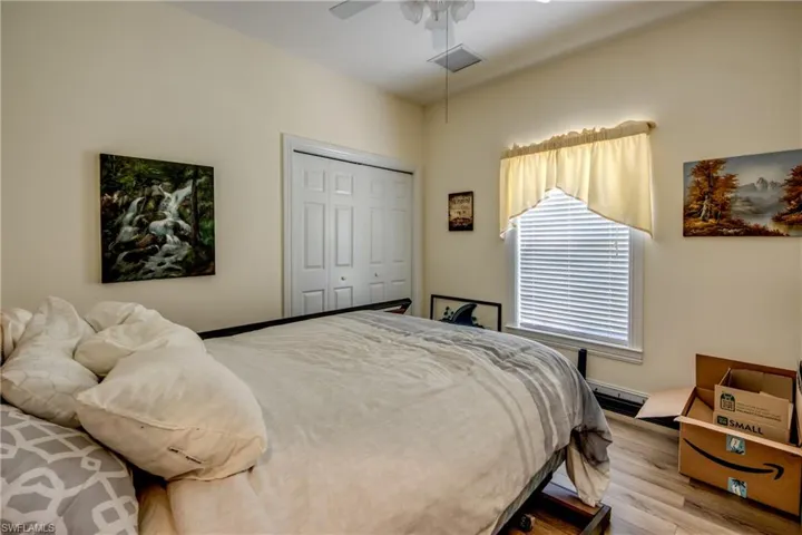 Bedroom with wood finished floors, a closet, and ceiling fan