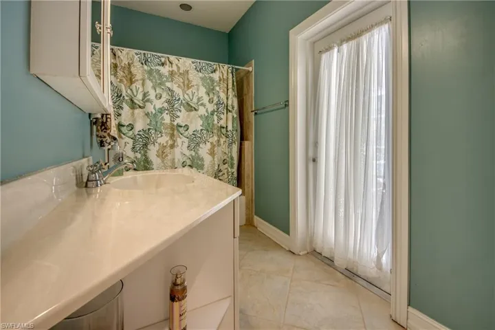 Full bath with vanity and tile patterned flooring