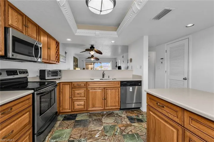 Kitchen with stainless steel appliances and ample quality wood cabinetry