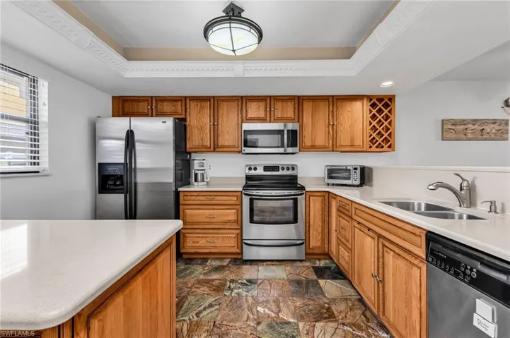Kitchen with stainless steel appliances and ample quality wood cabinetry