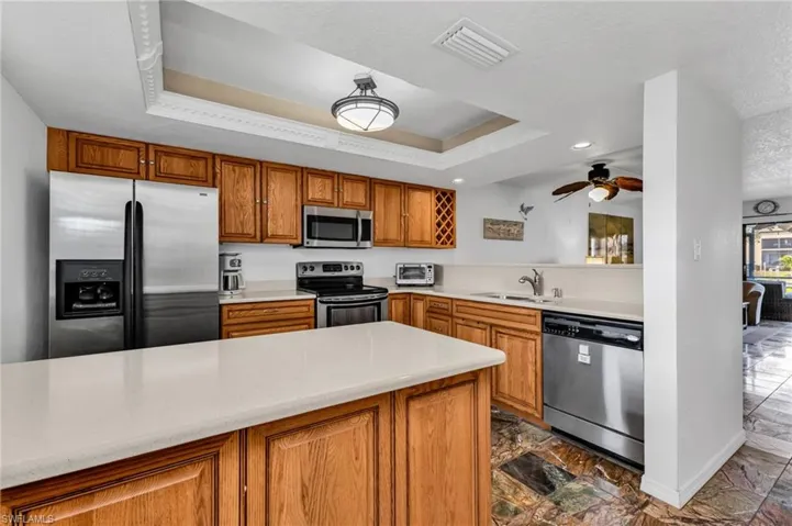 Kitchen with stainless steel appliances and ample quality wood cabinetry