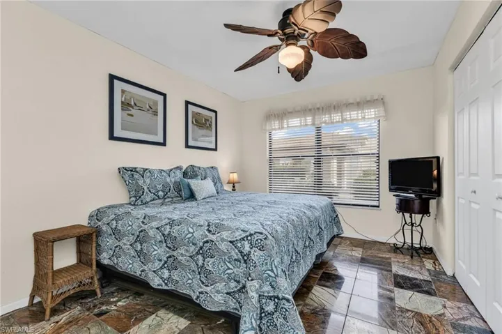Guest bedroom with built-in closet, ceiling fan