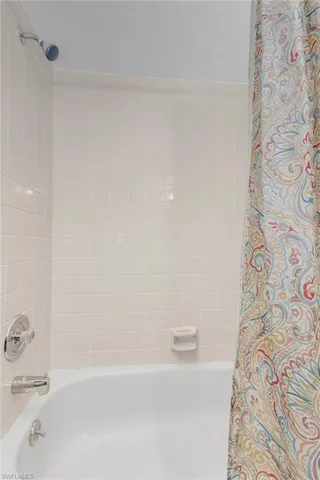 Guest bathroom featuring tile shower / bath combo