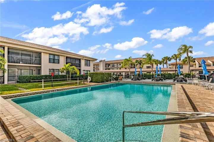 Heated community pool with nearby bathrooms and outdoor shower