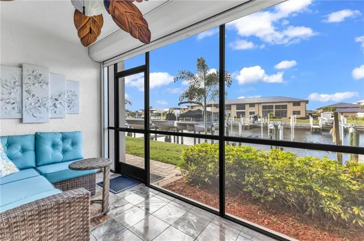 Screened lanai with view of boat dock and evening sunsets