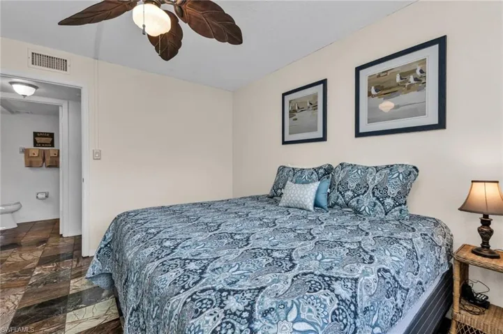 Guest bedroom with built-in closet, ceiling fan