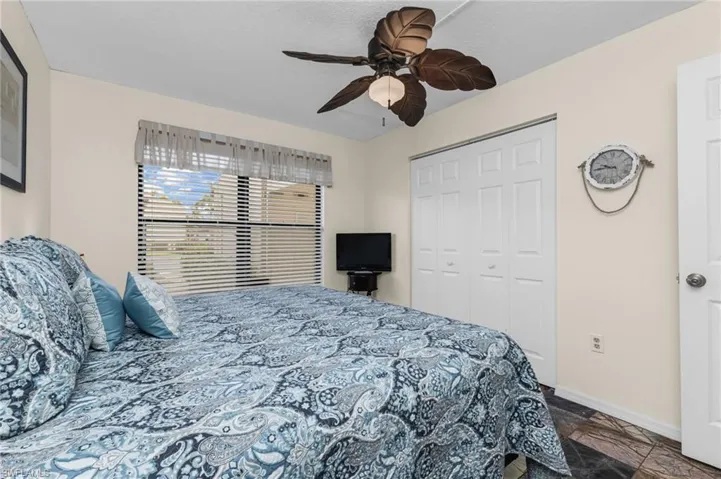 Guest bedroom with built-in closet, ceiling fan