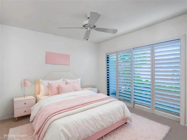 Carpeted bedroom with ceiling fan