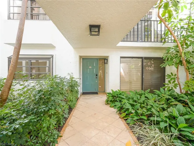 Property entrance featuring stucco siding