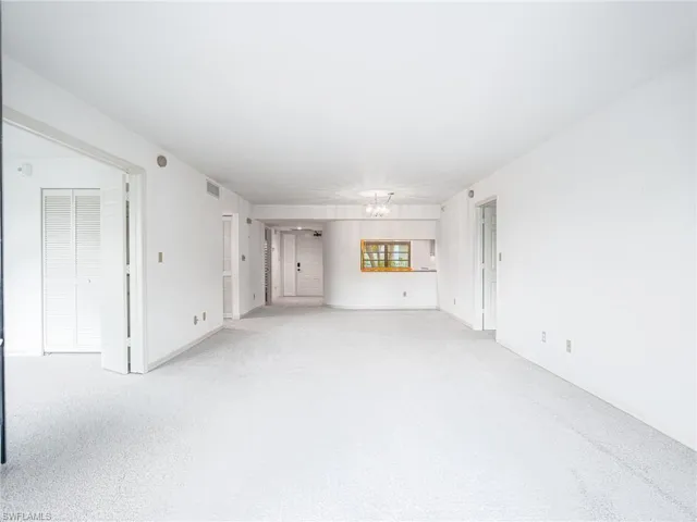 Unfurnished living room with light carpet