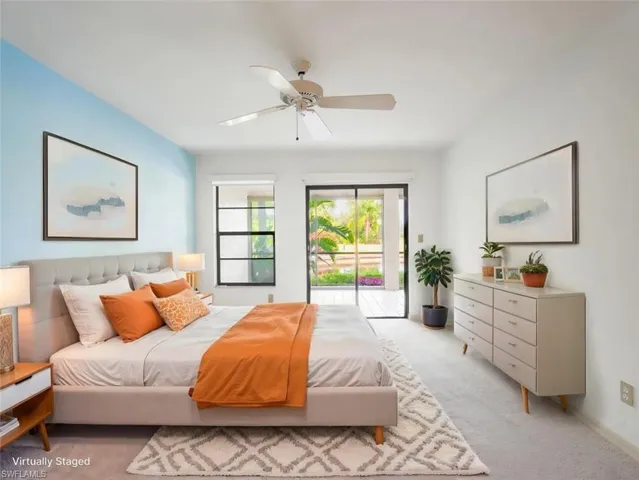 Bedroom featuring light carpet, access to exterior, and ceiling fan