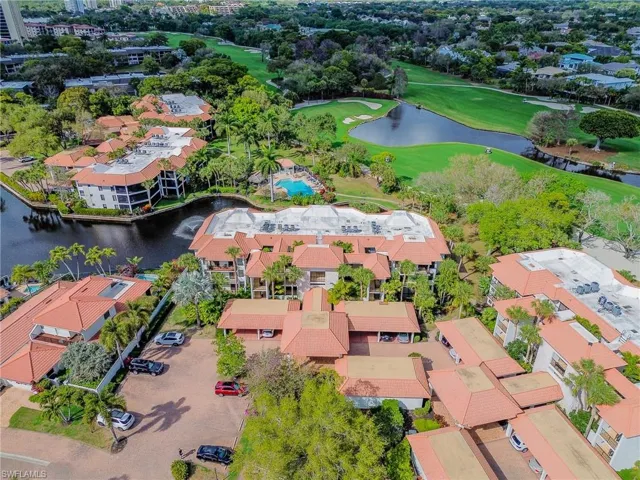 Drone / aerial view of a nearby body of water and a golf club
