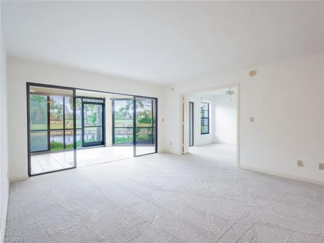 Living room with light carpet and a ceiling fan
