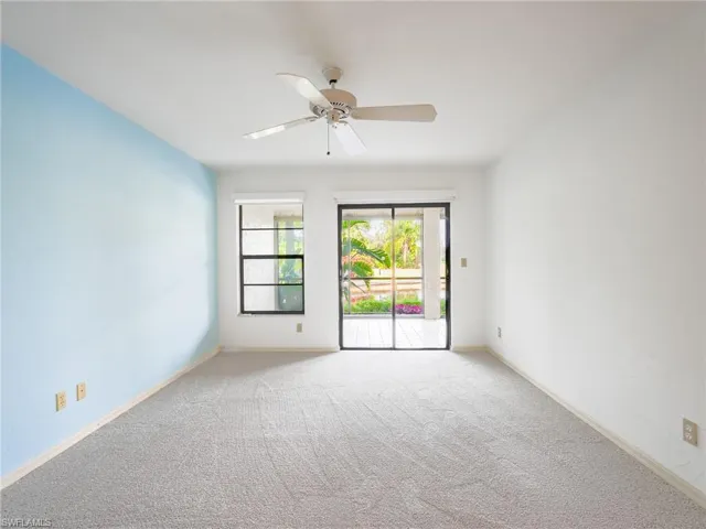 Spare room featuring light colored carpet and ceiling fan